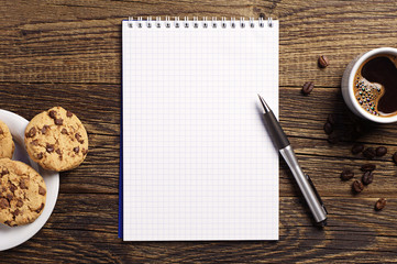 Notepad and coffee with cookies - obrazy, fototapety, plakaty