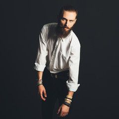 Young handsome man in white shirt on black background