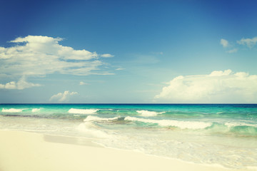 Fototapeta na wymiar blue sea or ocean, white sand and sky with clouds