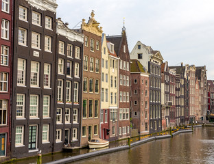 Fototapeta na wymiar Houses in Damrak district of Amsterdam