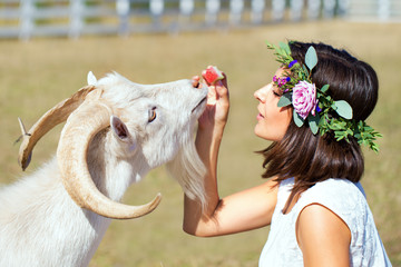 Funny picture a beautiful young girl farmer with a wreath on her