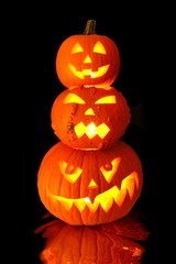 Group of stacked Halloween Jack o Lanterns on black