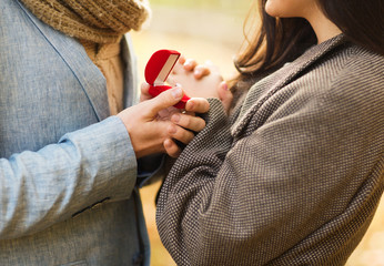 close up of couple with gift box in park