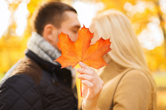 close up of couple kissing in autumn park