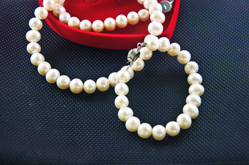 Pearl necklace against a black background