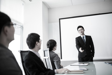 businessman giving a presentation to his colleagues