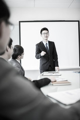 businessman giving a presentation to his colleagues