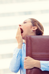 Fototapeta premium Sleepy young business woman, running to work yawning