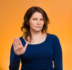 Fototapeta premium Annoyed woman with bad attitude, giving talk to hand gesture