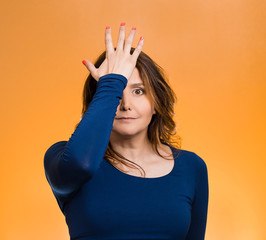 Woman realizes mistake, slapping hand on head to say duh