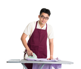 asian chinese male iron shirt and doing laundry work
