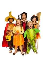 Kids with Halloween attributes in stage costumes