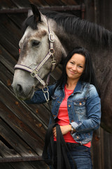 Beautiful young woman and gray horse portrait