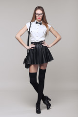 Beautiful woman is in fashion style in black mini skirt