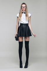 Beautiful woman is in fashion style in black mini skirt