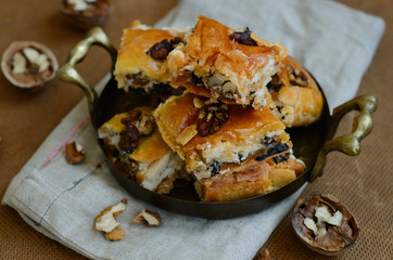 Brass tray with homemade baklava with honey, walnut and raisin