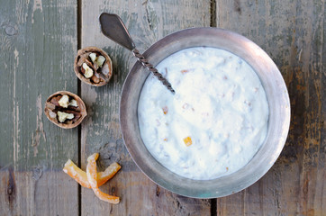 Homemade cottage cheese with walnut and sugared orange pieces in