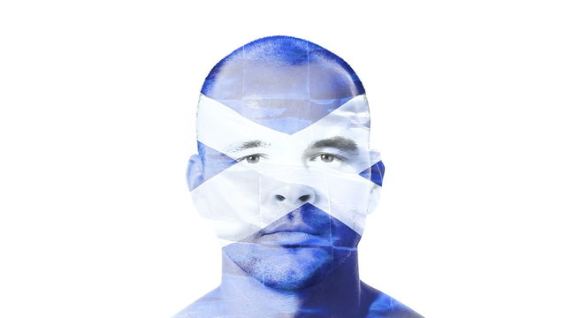 Flag of Scotland over a face of a young adult man.