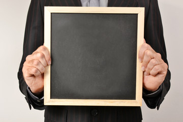 Businessman with blackboard