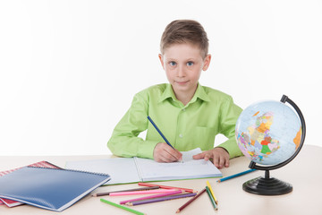 Caucasian student boy writing homework.