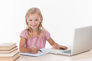 Student little school girl doing homework.