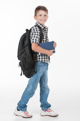 Happy schoolboy wearing backpack and holding books.