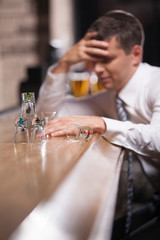 Pensive businessman having drink in classy bar.