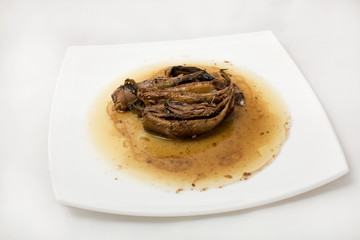 sprats on plate in oil on a white background