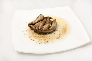 sprats on plate in oil on a white background