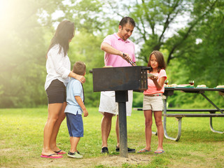 family barbecue - dad giving daughter cooked food