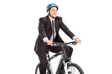 Fototapeta premium Young businessman riding a bicycle