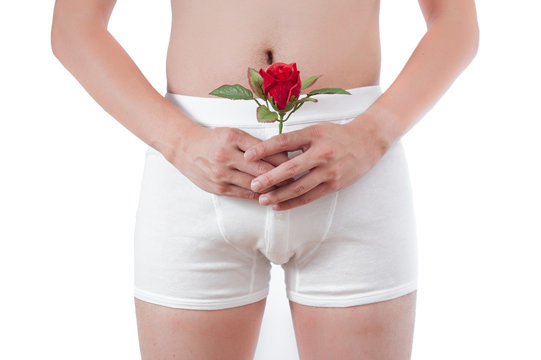 close up of man on white boxer underware  holding red rose isola