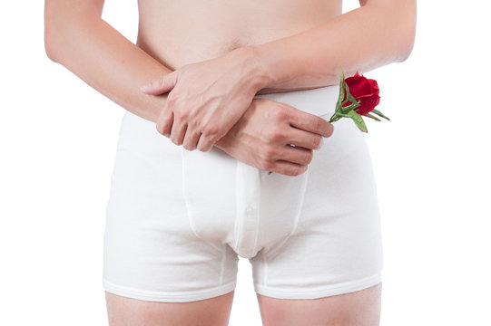 close up of man on white boxer underware  holding red rose isola