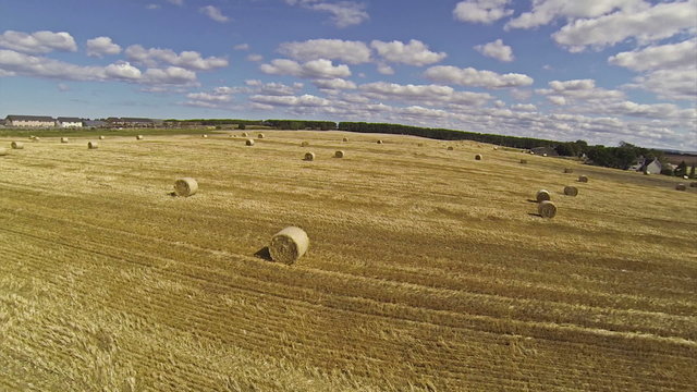 Two scenes of camera flying over bales of hay and very beautiful
