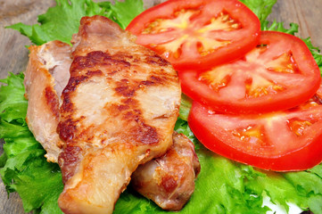 meat chops with tomatoes in a bowl
