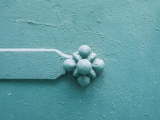 Metal flower on blue metal, textural background