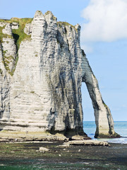 cape with arch on beach of Etretat