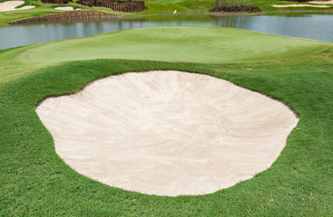 Sand bunker and clear lake on the beautiful golf course