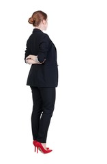 back view of redhead business woman contemplating.