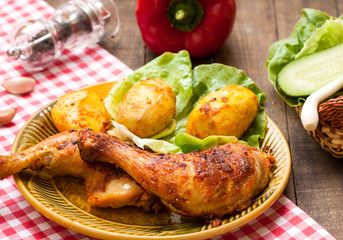 Roasted chicken legs with potatos and salad