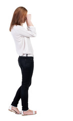 Back view of shocked woman in trousers.