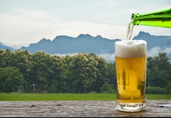 Foto auf Leinwand Enjoy beer with mountain landscape. © isuaneye