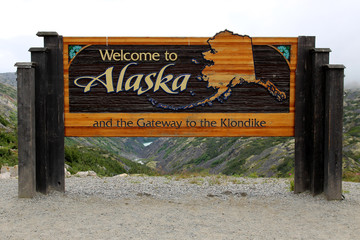Welcome to Alaska and the Gateway to the Klondike sign - 70035527