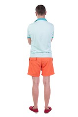 Fototapeta premium Back view of handsome man in shorts