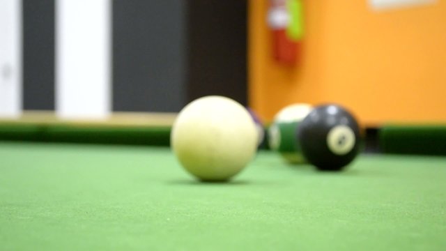 green felt table with pool table