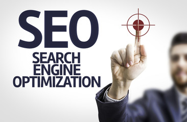 Business man pointing to transparent board with text: SEO