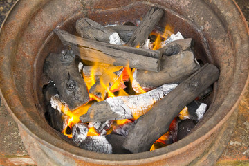 burning charcoal in metal rim