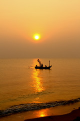 silhouette of fisherman and boat in the sea