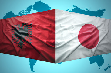 Waving Albanian and Japanese flags