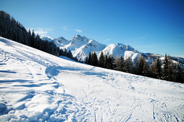 Alpine slope covered with white snow